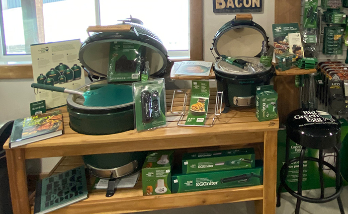 An arrangement of Big Green Egg grills and accessories
