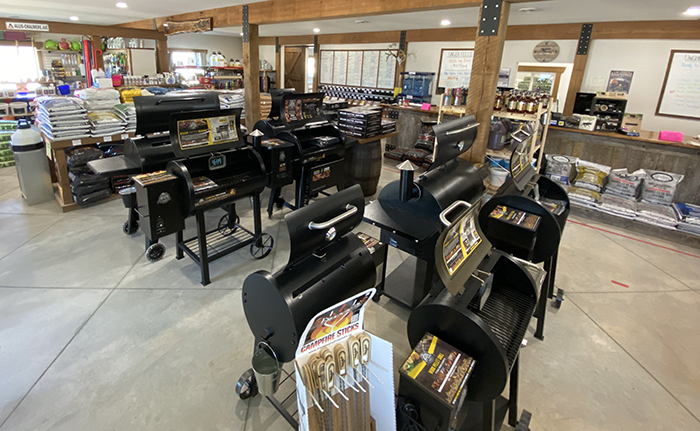 Several open grills on a floor display