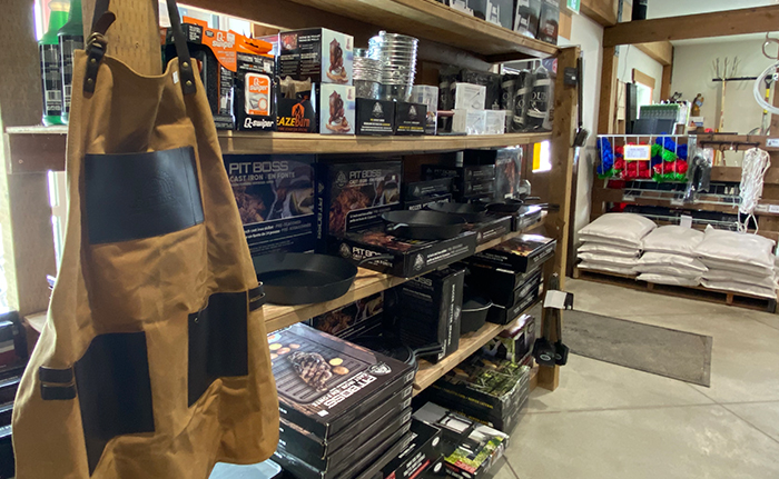 A shelf displaying a variety of grilling accessories